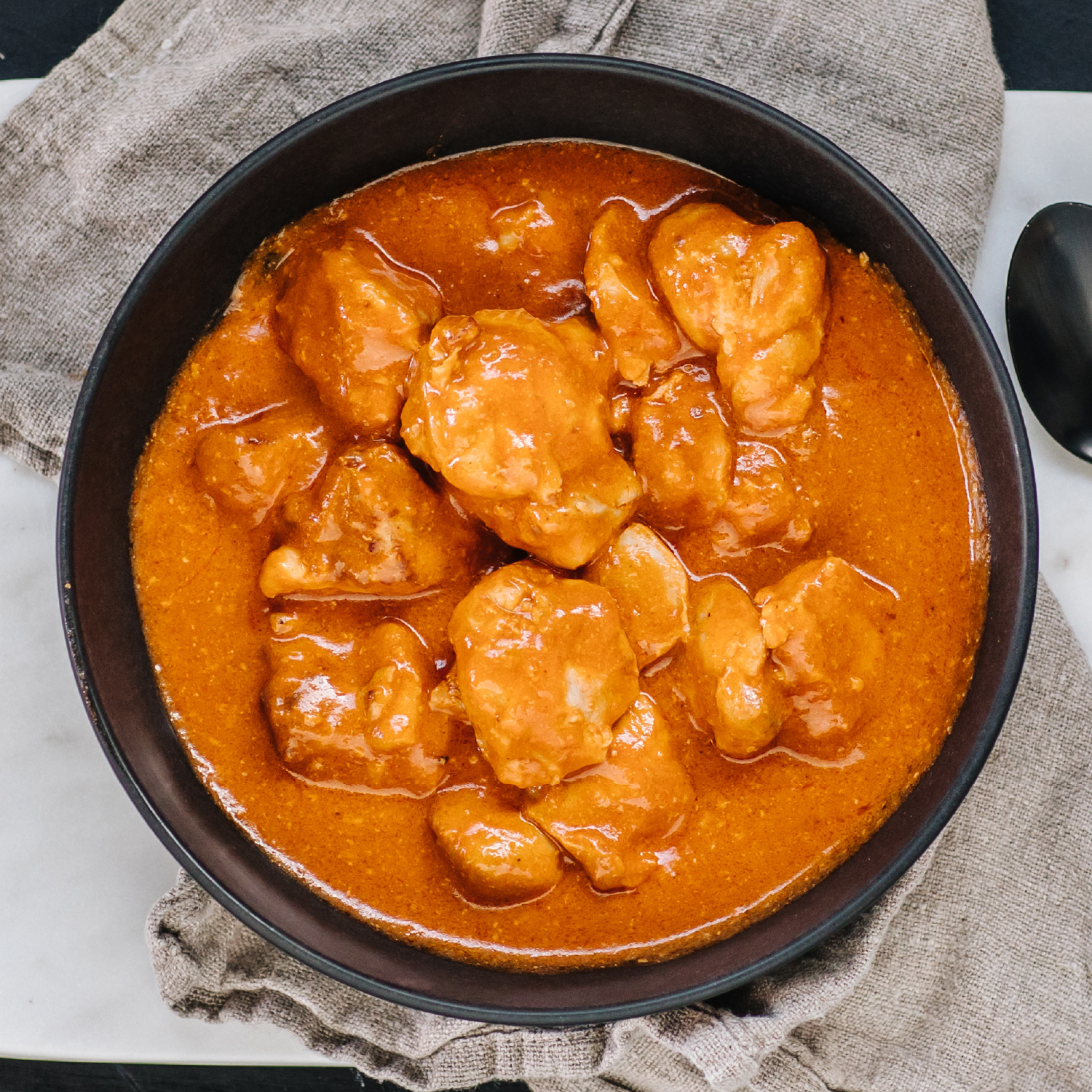 A traditional style, authentic Indian curry of succulent chicken, aromatic spices and a creamy tomato sauce.