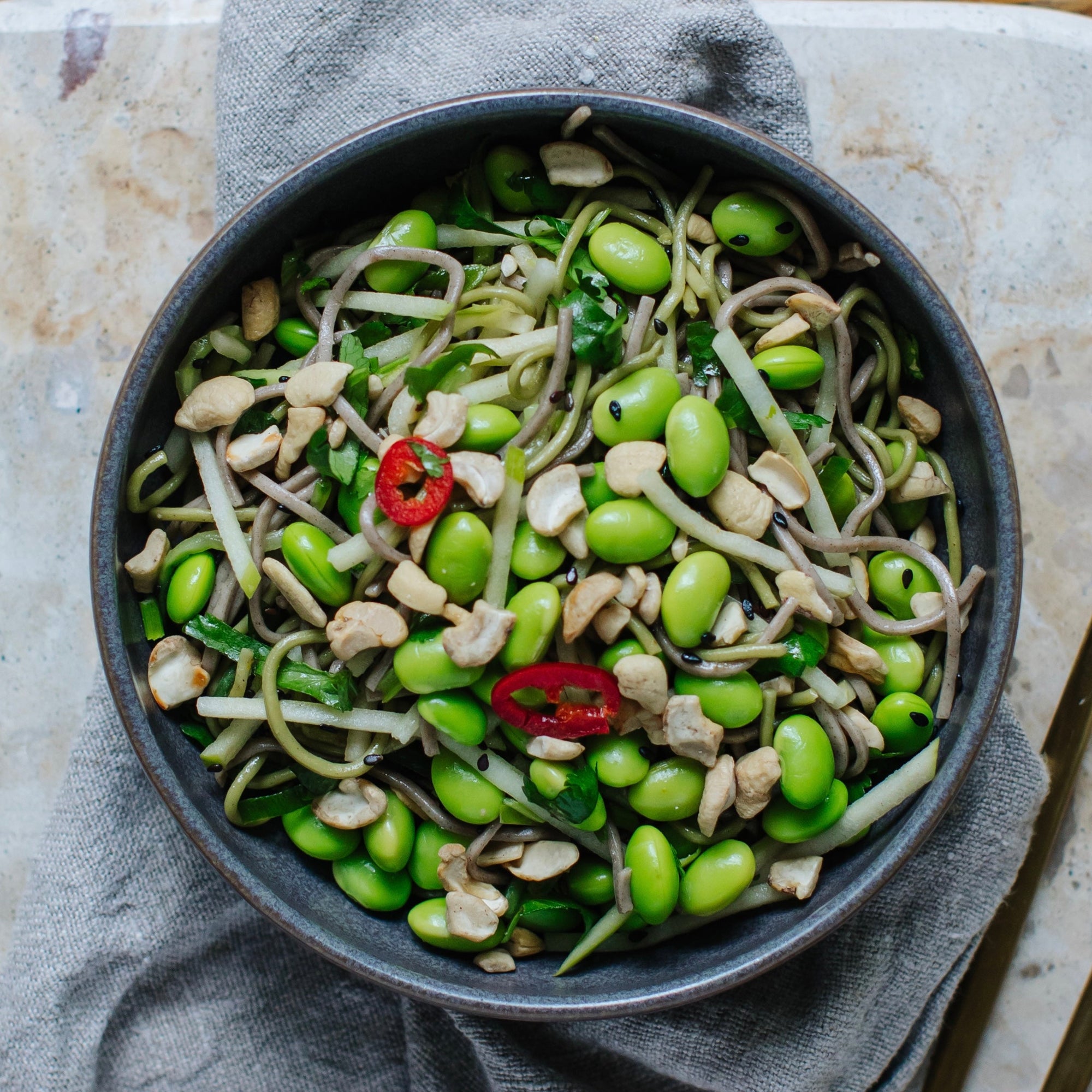 Soba noodle salad with edamame beans, cashews and a lemongrass dressing.