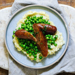 A Wagyu beef sausage with potato mash, peas and Paris butter.